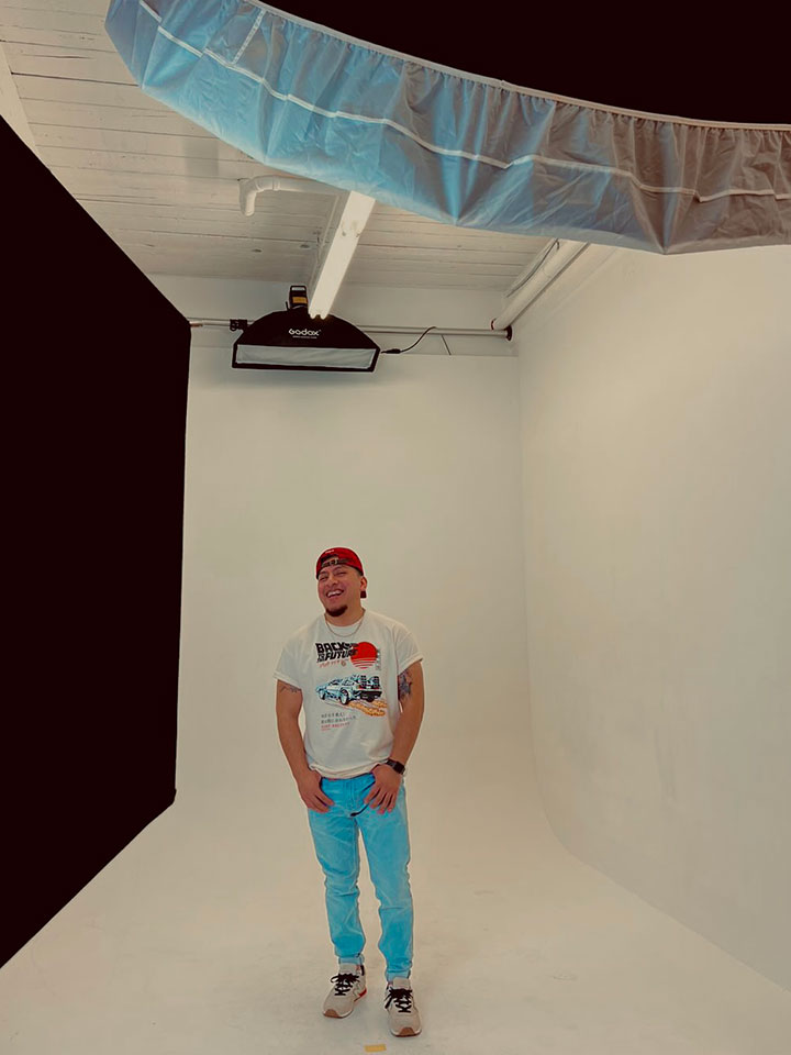 Gerson is posed in studio in front of a white backdrop.